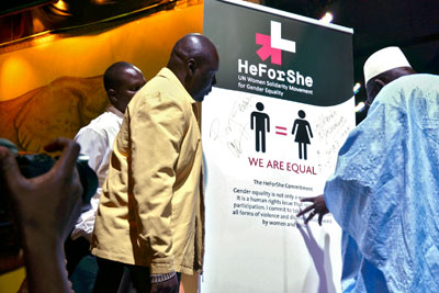 Male attendees sign the HeForShe Solidarity banner. Photo credit: UNWomen/Ruth W
