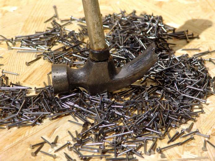 Hammer - nail puller and pile of nails